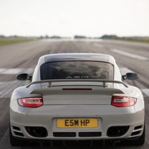 Rear view of a white Porsche on a runway.