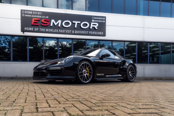 Black Porsche ES750 parked in front of ESMotor building.