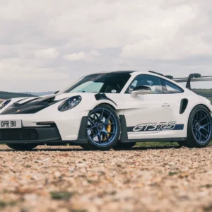 White Porsche 911 GT3 RS parked on a gravel road.