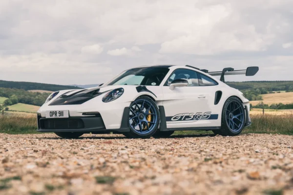 White Porsche 911 GT3 RS parked on a gravel road.