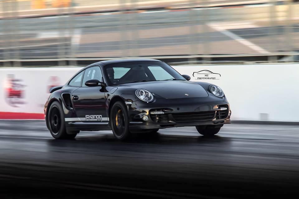 Porsche 992 Turbo S racing on track with enhanced suspension