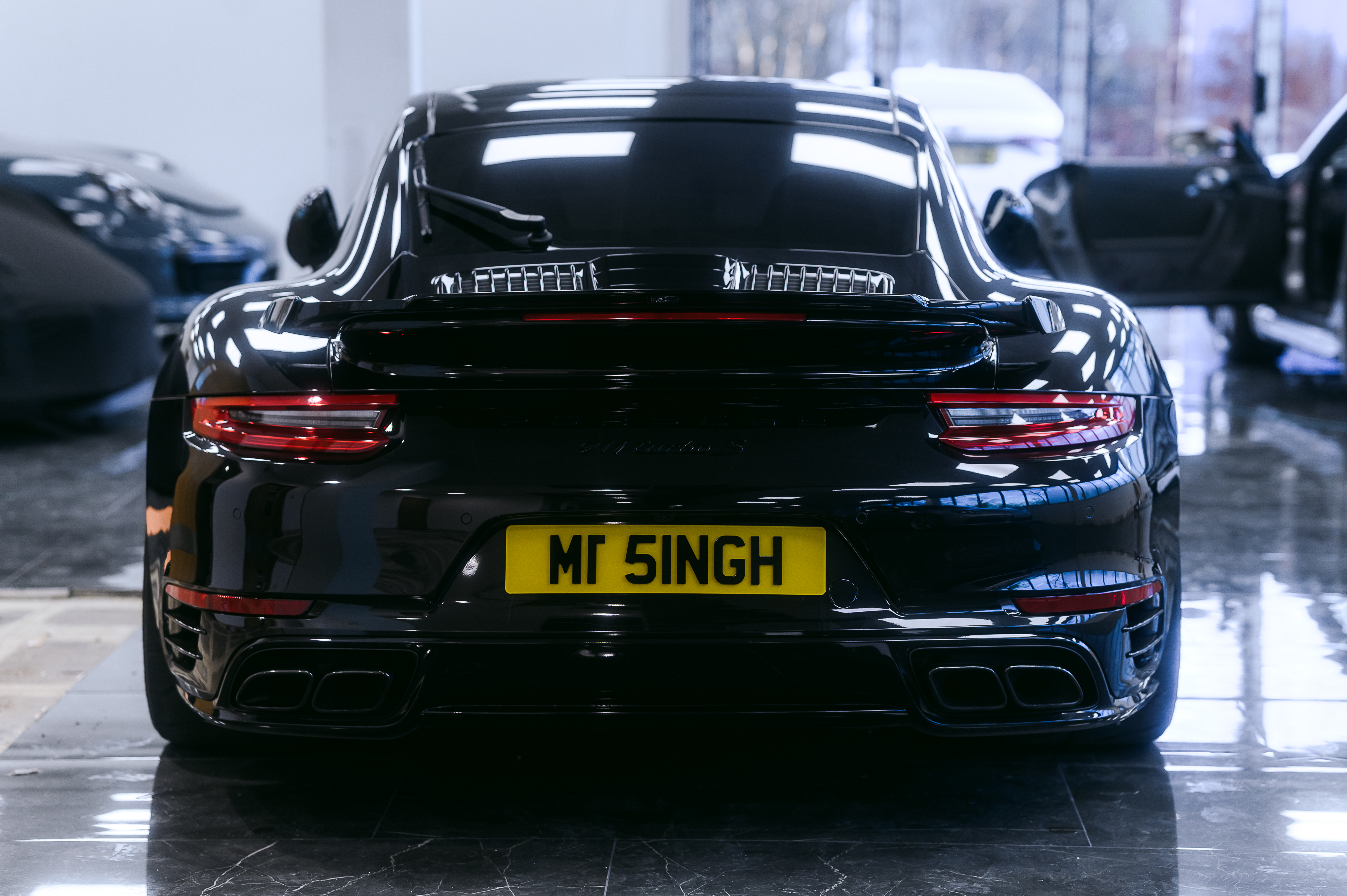 Porsche 992 Turbo S in a garage during suspension work