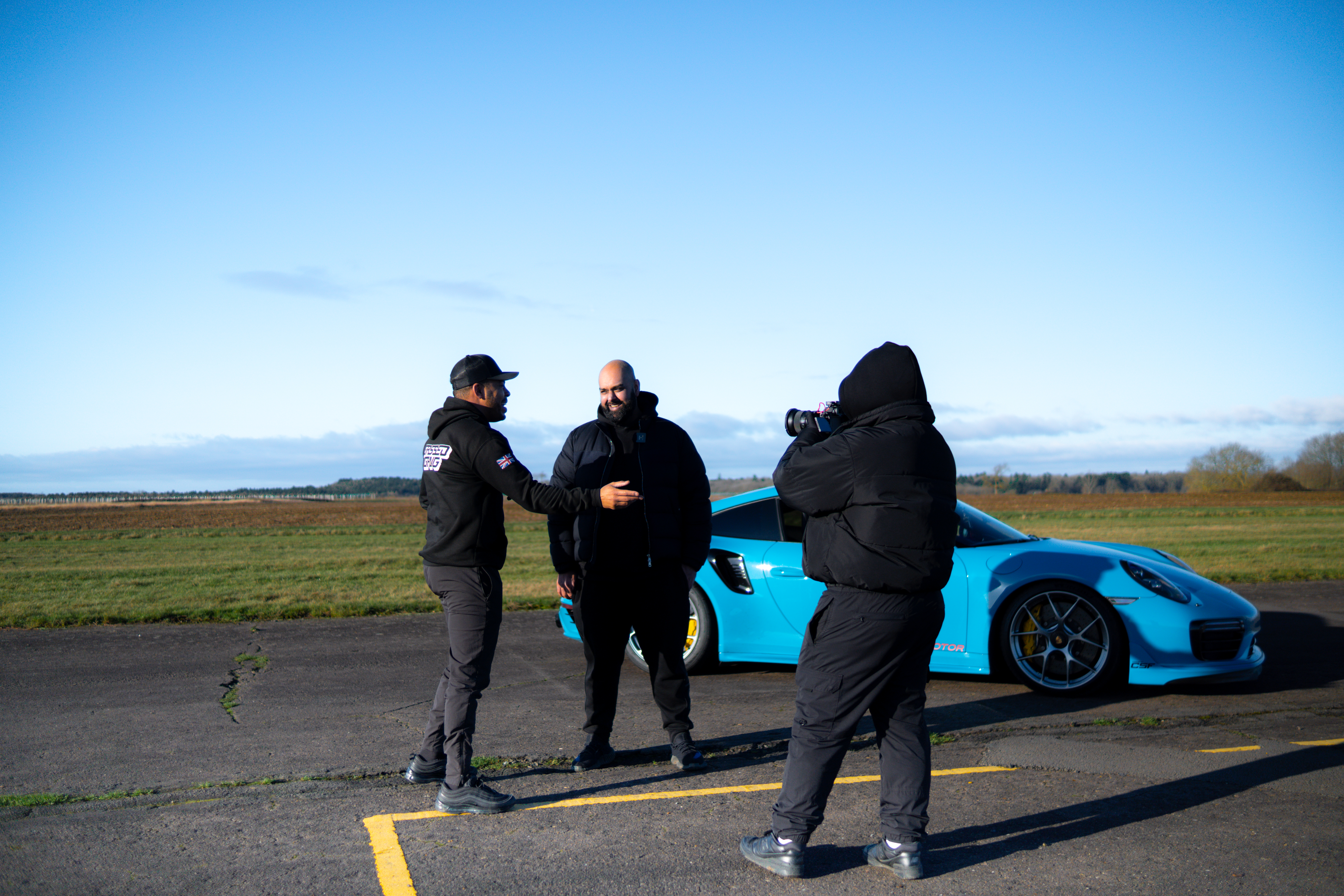 Porsche mechanics sharing advice in workshop